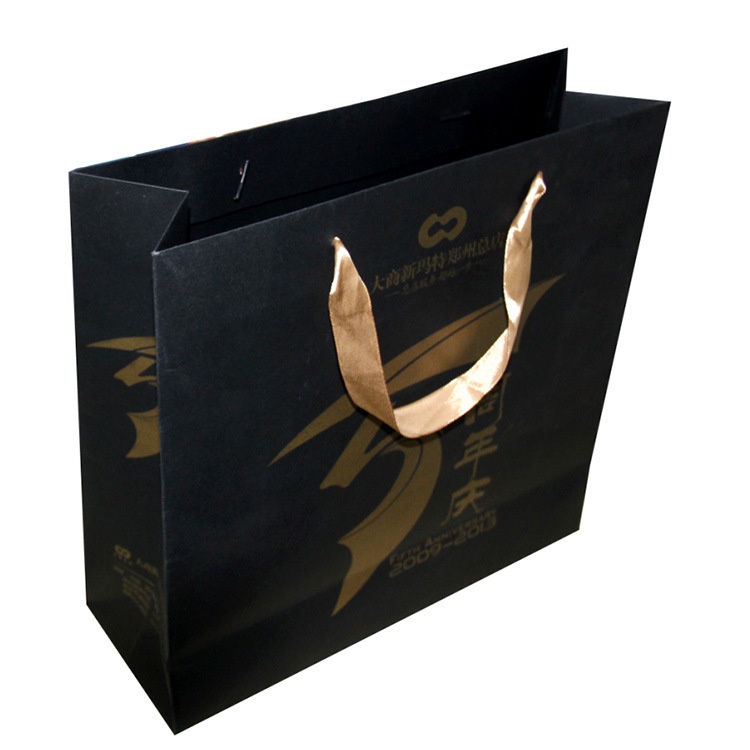Shopping paper bag with rope handles for clothing packaging Shopping paper bag with rope handles for clothing packaging